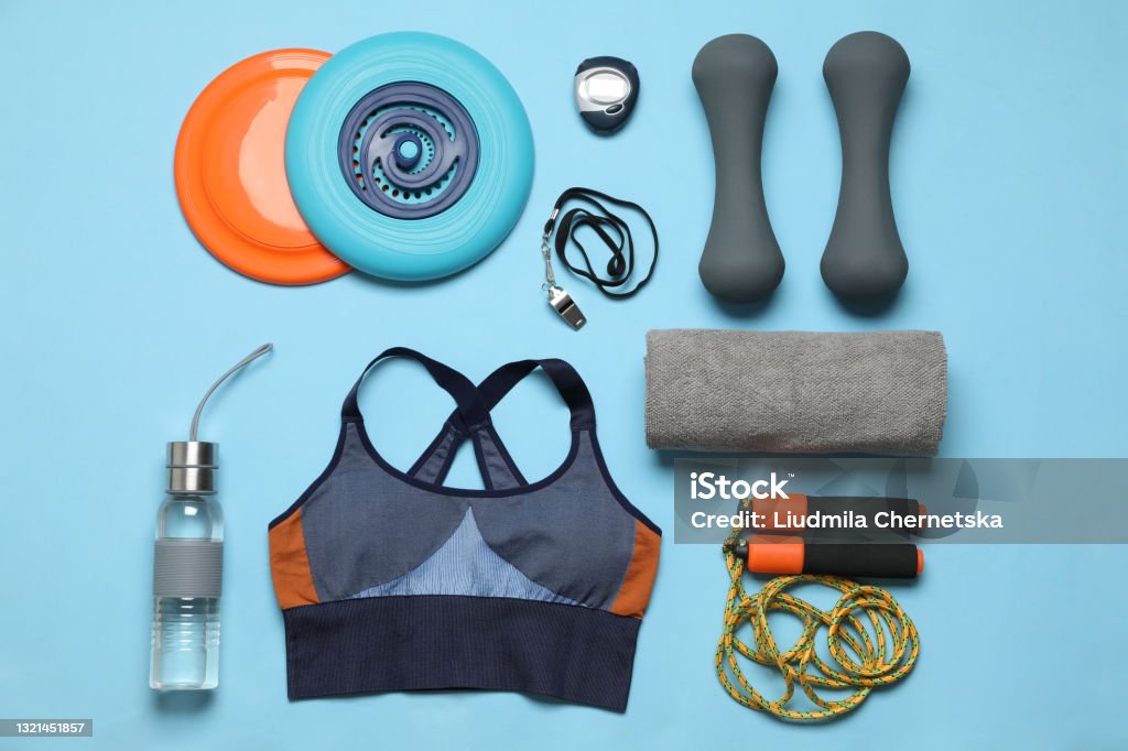 Flat lay composition with sports equipment on light blue background Sports Clothing Stock Photo