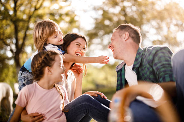 istock Cheerful family having fun on a picnic in spring day. 1321451932