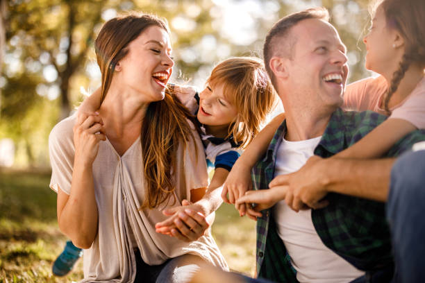 istock Happy family having fun while talking in spring day at the park. 1321452160