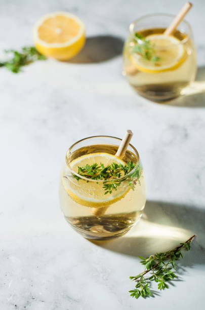 istock Refreshing lemonade with a slice of lemon and a straw. Hard shadows. Summer drinks. Copy space. 1321452308