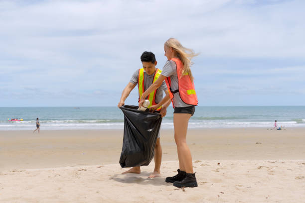 istock Young adult cleaning the beach. 1321453836