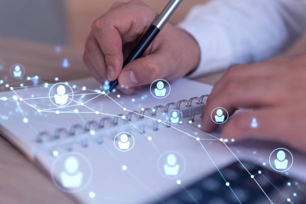 istock HR specialist is taking notes concerning new candidates to create international network in recruitment process. Concept of success. Social media hologram icons. Formal suit 1321454376
