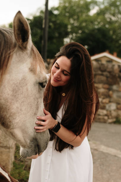 istock Young woman with horse 1321454969