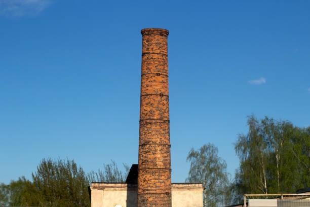 istock Factory brick pipe. A brick chimney rises against the sky. 1321456184
