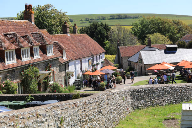 East Dean, Eastbourne East Dean - May 31, 2021: Tourists and locals enjoy the sunny day with a beer in the famous bar of The Tiger inn pub.
A beautiful South Downs village close to Beachy Head and Birling Gap beach, East Dean, Eastbourne, UK. table ledge stock pictures, royalty-free photos & images