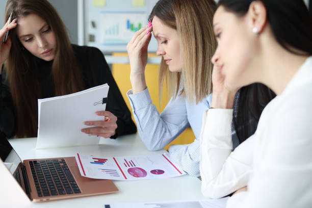 istock Tired business woman is sitting in thoughtful state at table 1321458832