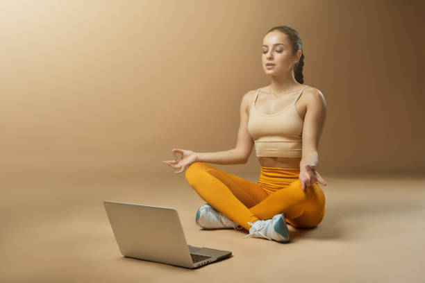 istock Beautiful young woman using laptop and meditating 1321459900