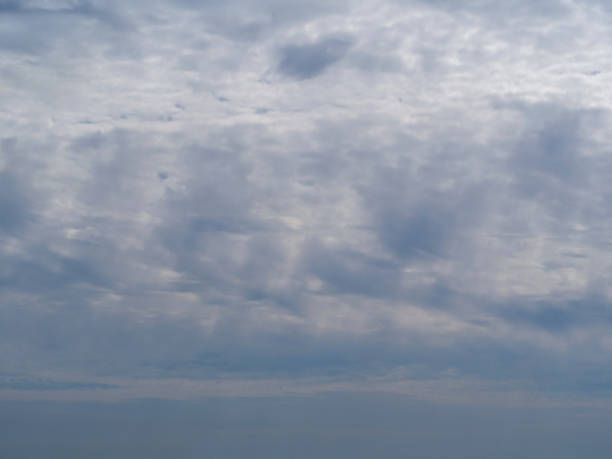 istock Natural sky background. Blue sky with multicolored clouds through which the rays of the sun break through. 1321461527