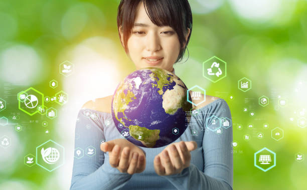 Young asian girl watching the earth. Environmental protection  concept. Sustainable development goals. SDGs. Young asian girl watching the earth. Environmental protection  concept. Sustainable development goals. SDGs. Elements of this image furnished by NASA (url:https://earthobservatory.nasa.gov/blogs/elegantfigures/wp-content/uploads/sites/4/2011/10/land_shallow_topo_2011_8192.jpg) low carbon economy stock pictures, royalty-free photos & images