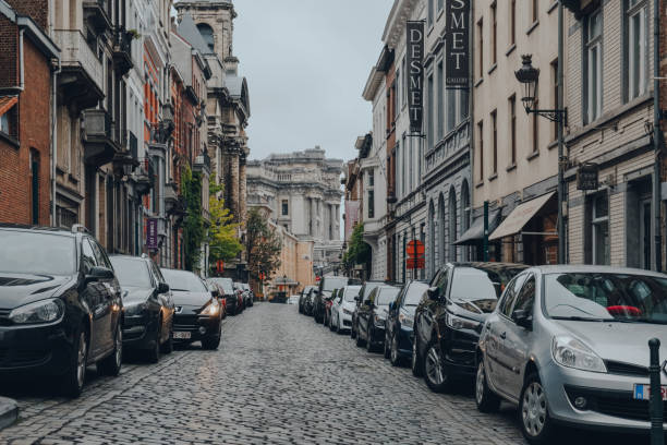 Cars parked on both sides of a narrow street in Brussels, Belgium. stock photo