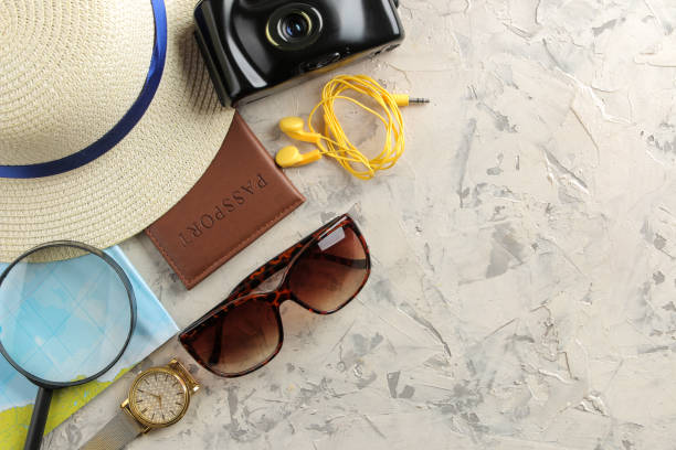 istock Travel concept hat, passport, map, camera and sunglasses on a light concrete background. top view 1321462035