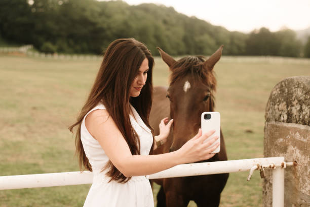 istock Young woman taking a selfie with a horse 1321463584