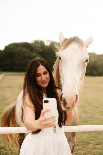 istock Young woman taking a selfie with a horse 1321463585