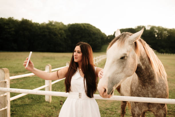 istock Young woman taking a selfie with a horse 1321463639