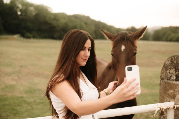 istock Young woman taking a selfie with a horse 1321464163