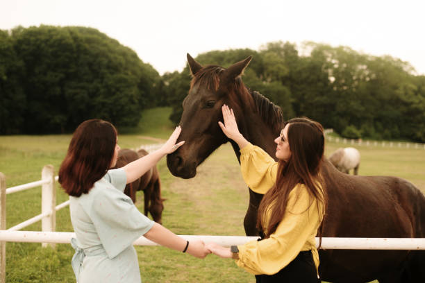 istock Two young women with a horse 1321464206