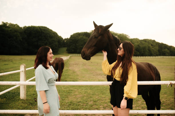 istock Two young women with a horse 1321464244