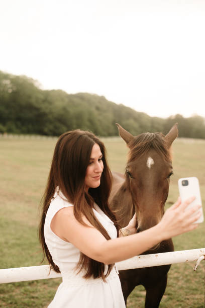 istock Young woman taking a selfie with a horse 1321464424