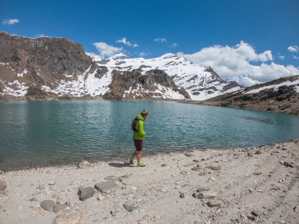 istock Male trail runner contemplates alpine lake 1321464472