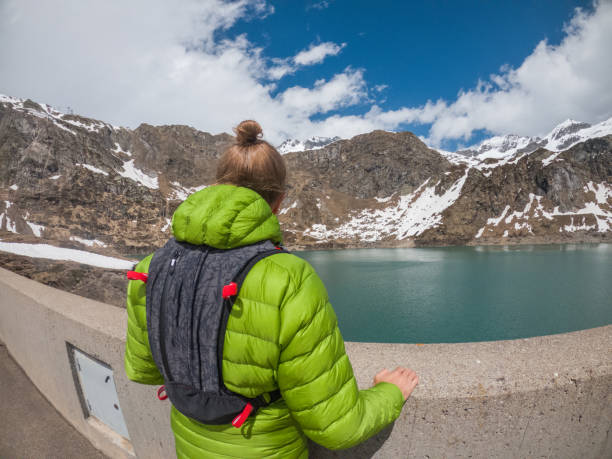 istock Male trail runner contemplates alpine lake 1321464497