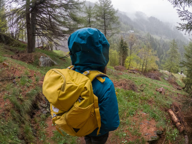 istock Woman hiking under the rain 1321464528