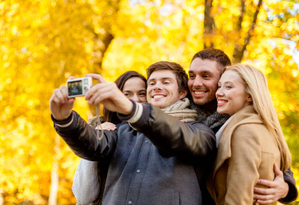 istock group of smiling men and women making selfie 1321465926