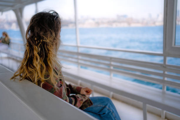 istock Woman with protective face mask on the ferry 1321466078