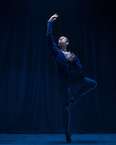 Young and graceful ballet dancer isolated on dark background in neon light. Art, action, inspiration concept.