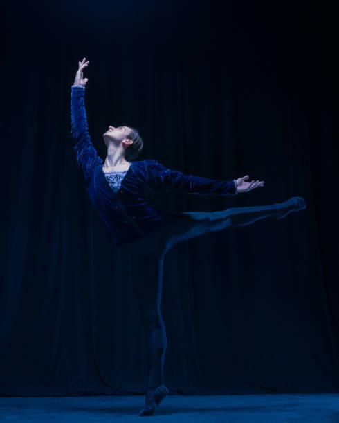 istock Young and graceful ballet dancer isolated on dark background in neon light. Art, action, inspiration concept. 1321467979