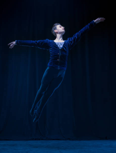 istock Young and graceful ballet dancer isolated on dark background in neon light. Art, action, inspiration concept. 1321467986
