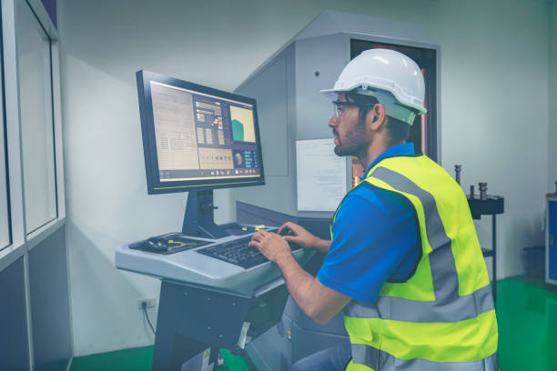 istock Assistant using control machine operating control CNC machinery at factory Industrial. 1321473307