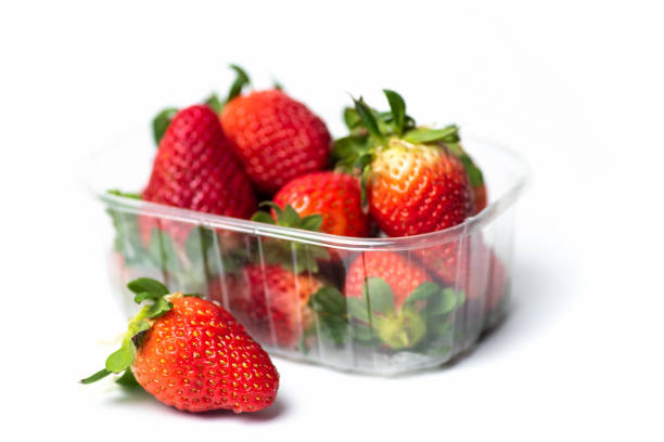istock Raw fresh strawberry in a package on white background 1321473355