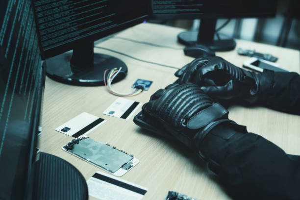 istock Shot from the Back to Hacker Breaking into Corporate Data Servers from His Underground Hideout. close view of hackers hands 1321475483