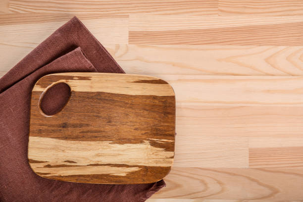 istock Wooden cutting board on wooden table 1321477697