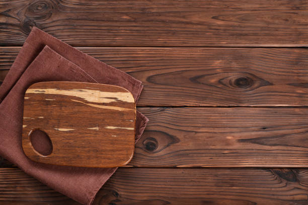 istock Wooden cutting board on wooden table 1321477709
