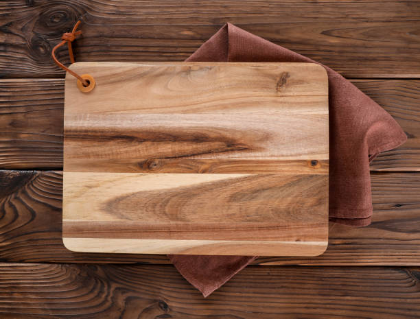 istock Wooden cutting board on wooden table 1321477727