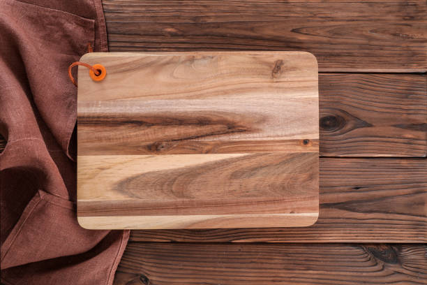 istock Wooden cutting board on wooden table 1321477764