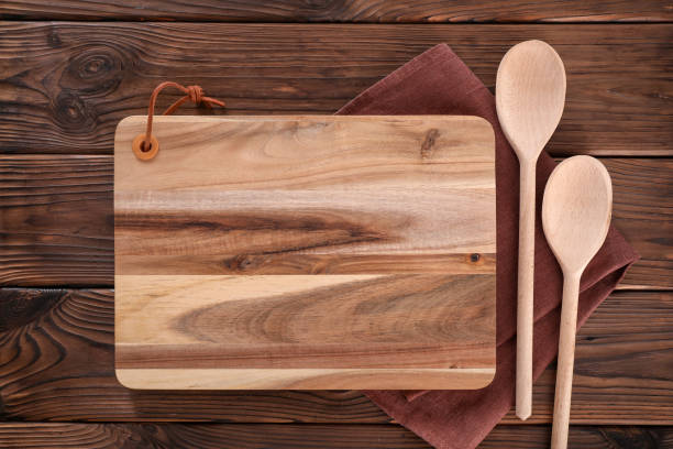 istock Cutting board with kitchen appliances on wooden table 1321477790