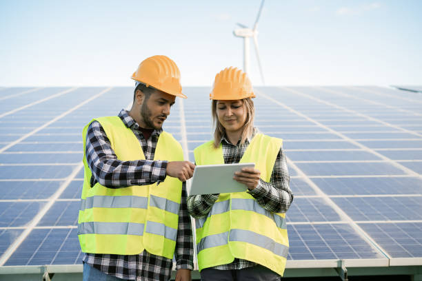 istock Young people working with digital tablet at renewable energy farm - Focus on faces 1321479457