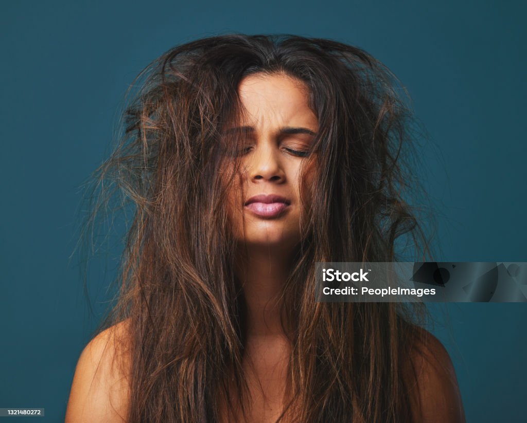Studio Shot Of A Beautiful Young Woman With Messy Hair Posing ...