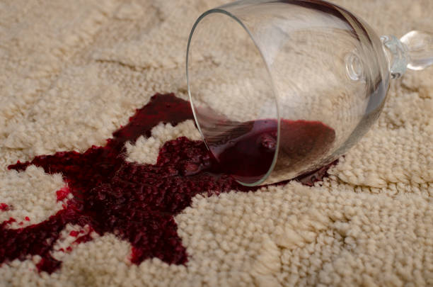 A glass of red wine fell on the carpet, wine spilled on the carpet Home mishap and domestic accident concept with close up of a spilled glass of red wine on brown carpet wine glass knocked over stock pictures, royalty-free photos & images