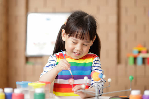 istock Cute Girl Looking At Camera On Table 1321482588
