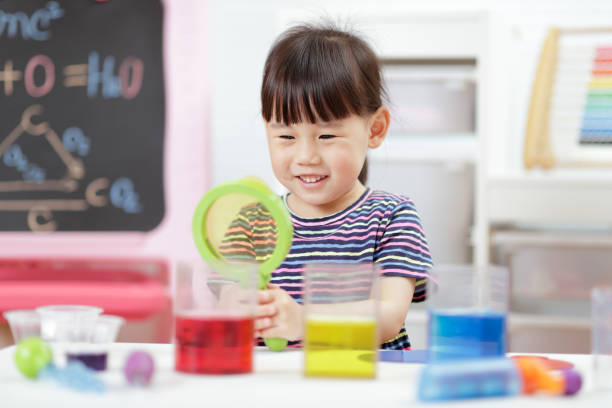 istock Cute Girl With Magnifying Glass While Playing At Home 1321483014