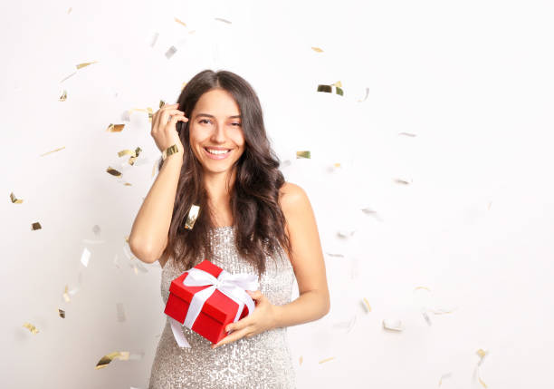istock Beautiful woman holding gift on white background 1321484017