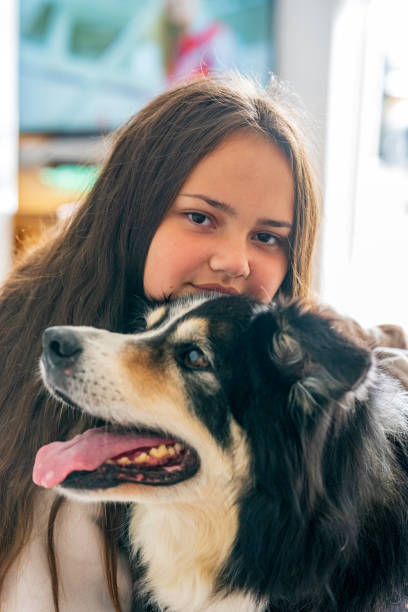 istock Thirteen year old girl with pet border collie 1321484329