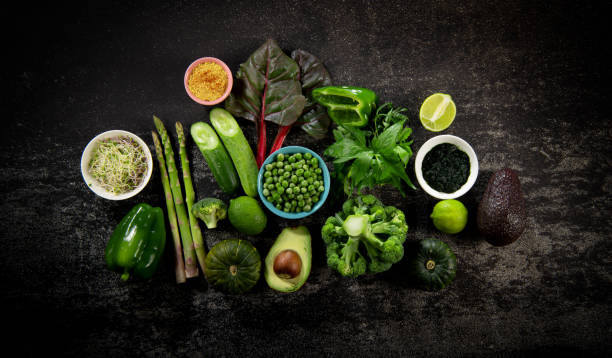 istock Collection of green vegetables on dark cement 1321484353