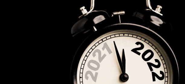 istock 2021 and 2022 on black alarm clock  with copy space on black background and copy space , Merry Christmas and Happy new year concept. 1321486409