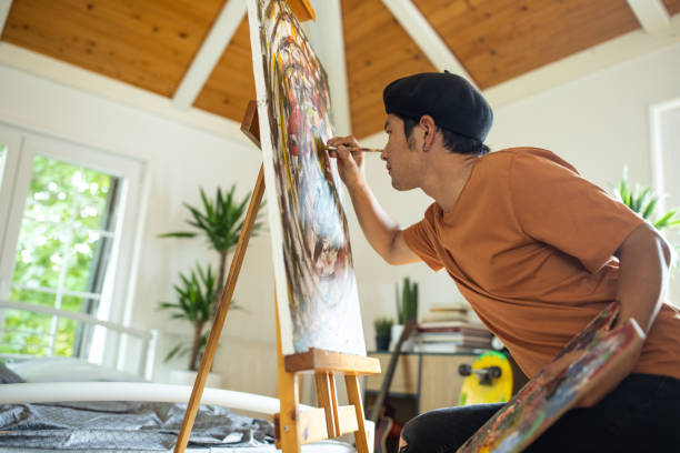 istock Japanese man making abstract painting on canvas at home 1321486718