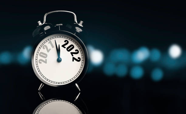 istock 2021 and 2022 on black alarm clock  with copy space on black background and copy space blue bokeh , Merry Christmas and Happy new year concept. 1321486739