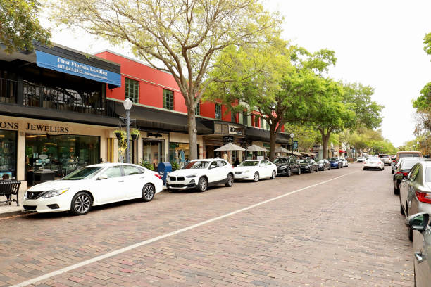 Famous Shopping Street in Winter Park Winter Park, Florida, USA - March 20, 2021: Retail stores on South Park Avenue in downtown Winter Park.  Famous for it's upscale shopping and world class museums. winter park florida stock pictures, royalty-free photos & images